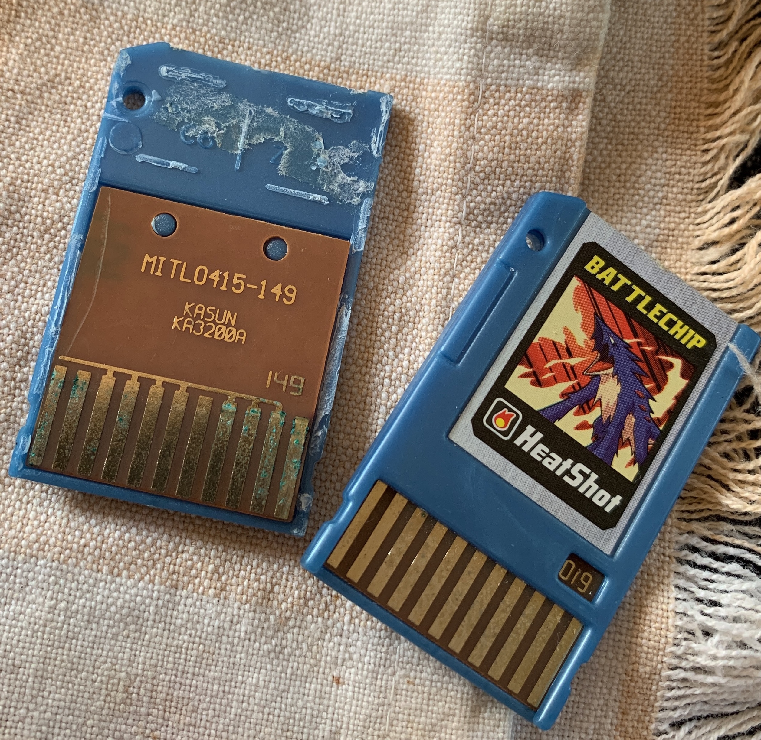 A cracked open Megaman Battle Network toy cartridge